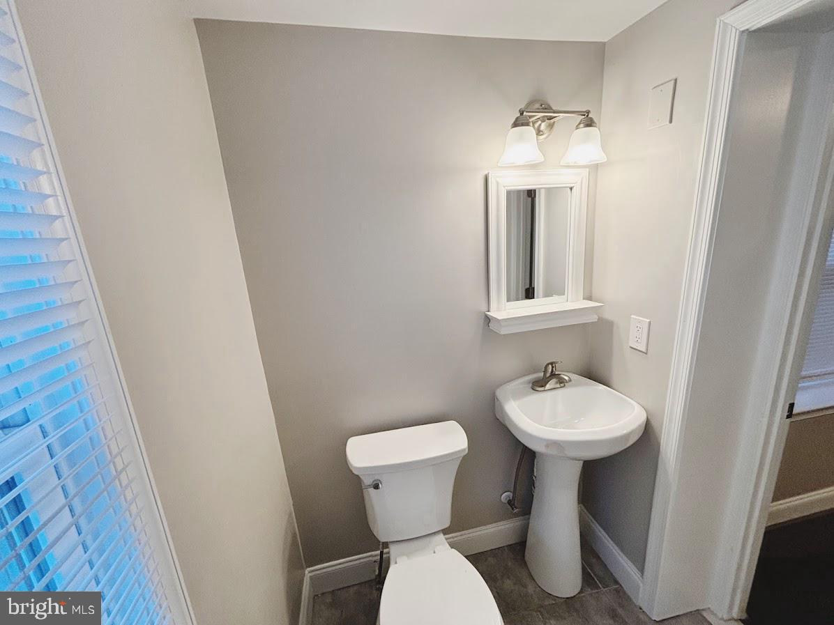 1721 North Bond Street Baltimore, MD 21213 - Photo 15 of 21 a bathroom with a sink toilet and a mirror