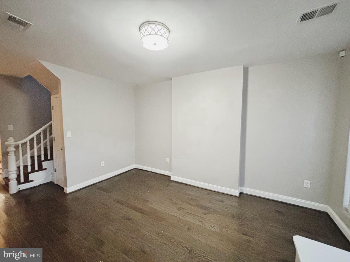 1721 North Bond Street Baltimore, MD 21213 - Photo 3 of 21 a view of an empty room with wooden floor and a window