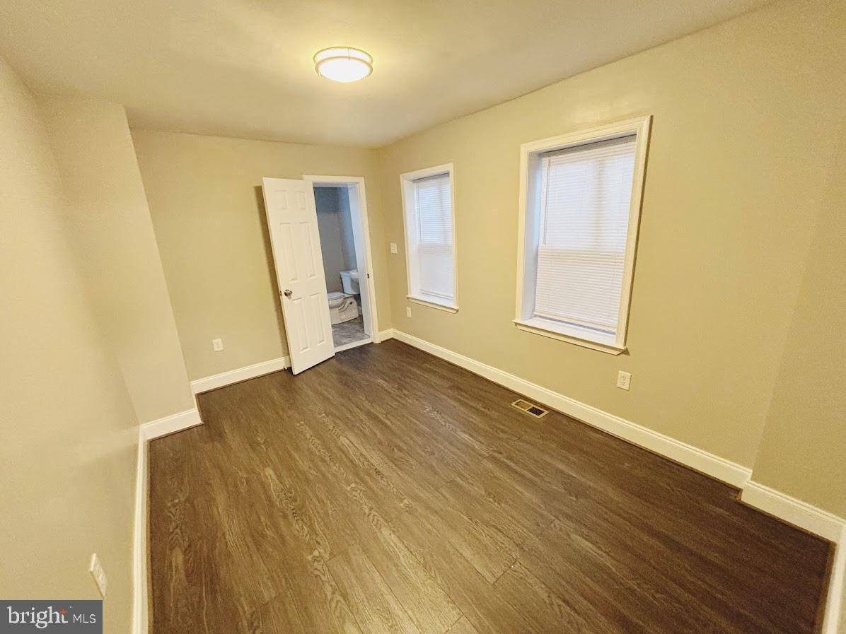 1721 North Bond Street Baltimore, MD 21213 - Photo 10 of 21 an empty room with wooden floor and windows