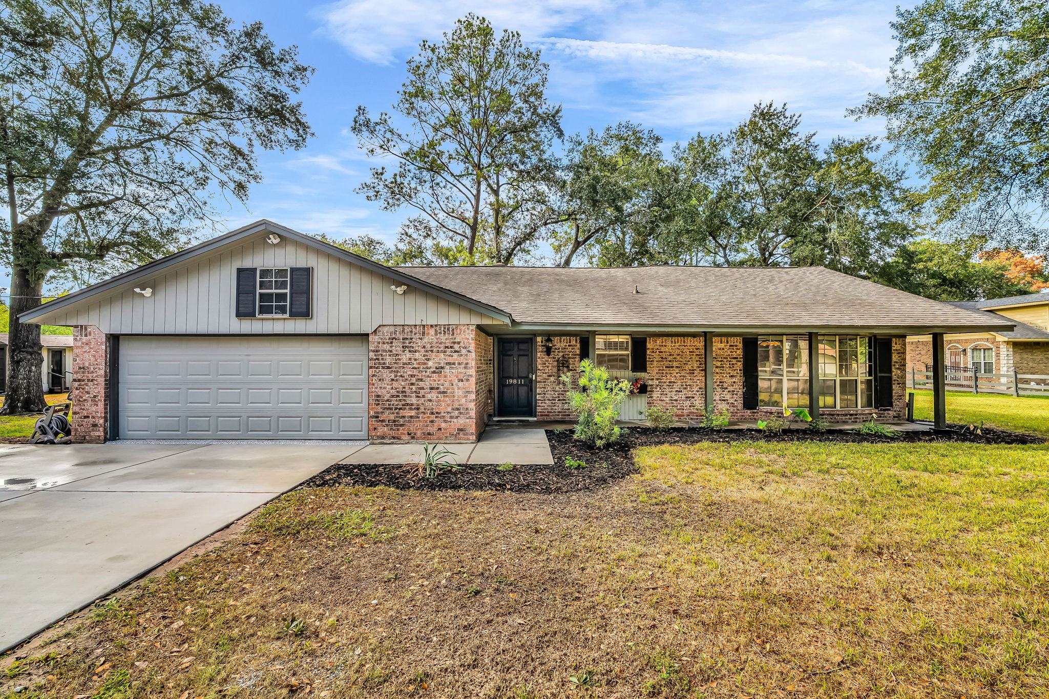19811 Sagging Oaks Drive Spring, TX 77388 - Photo 2 of 35 a front view of a house with a yard and garage