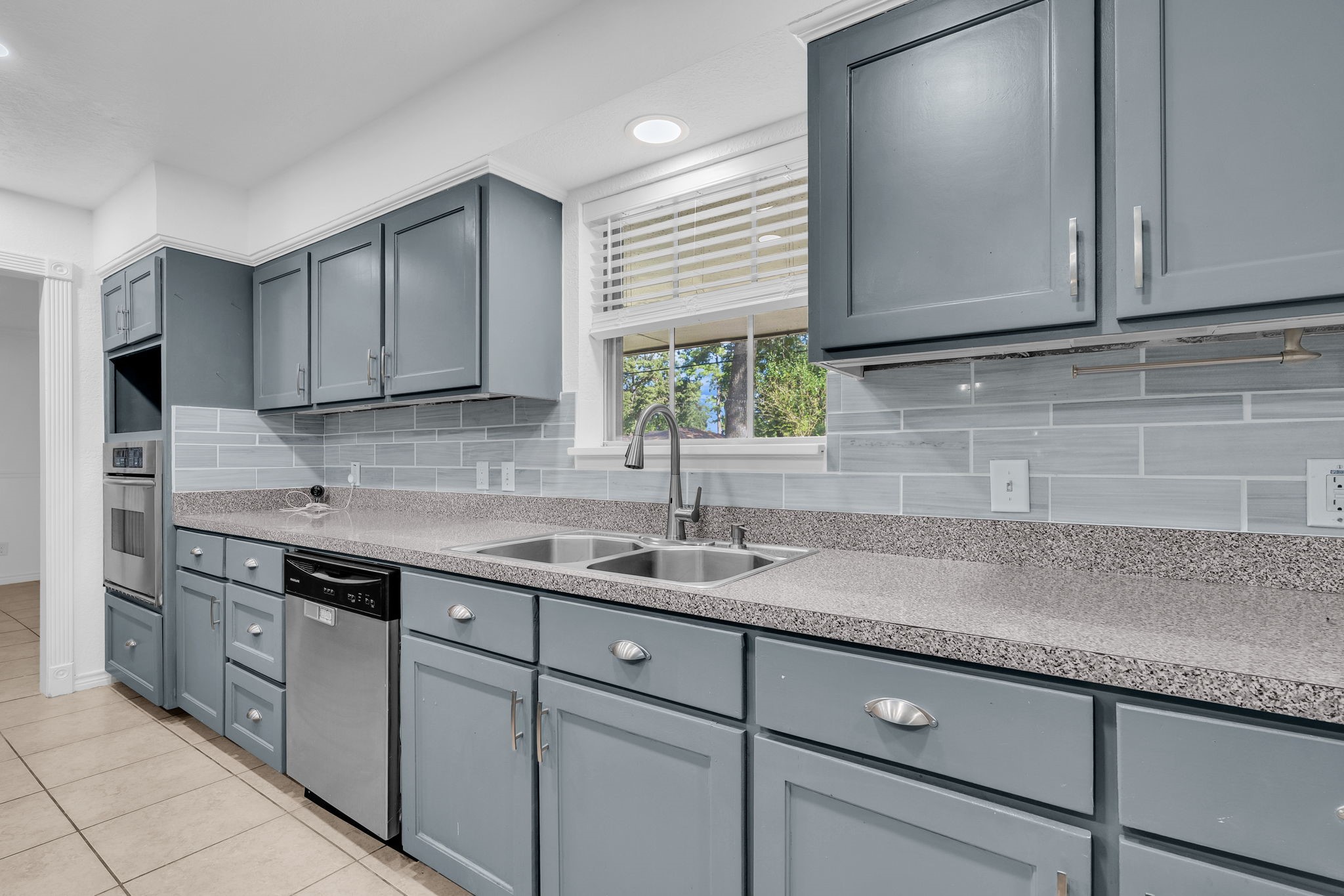 19811 Sagging Oaks Drive Spring, TX 77388 - Photo 8 of 35 a kitchen with stainless steel appliances granite countertop a sink a stove and cabinets