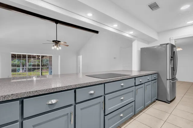 a kitchen with stainless steel appliances granite countertop a refrigerator and a sink