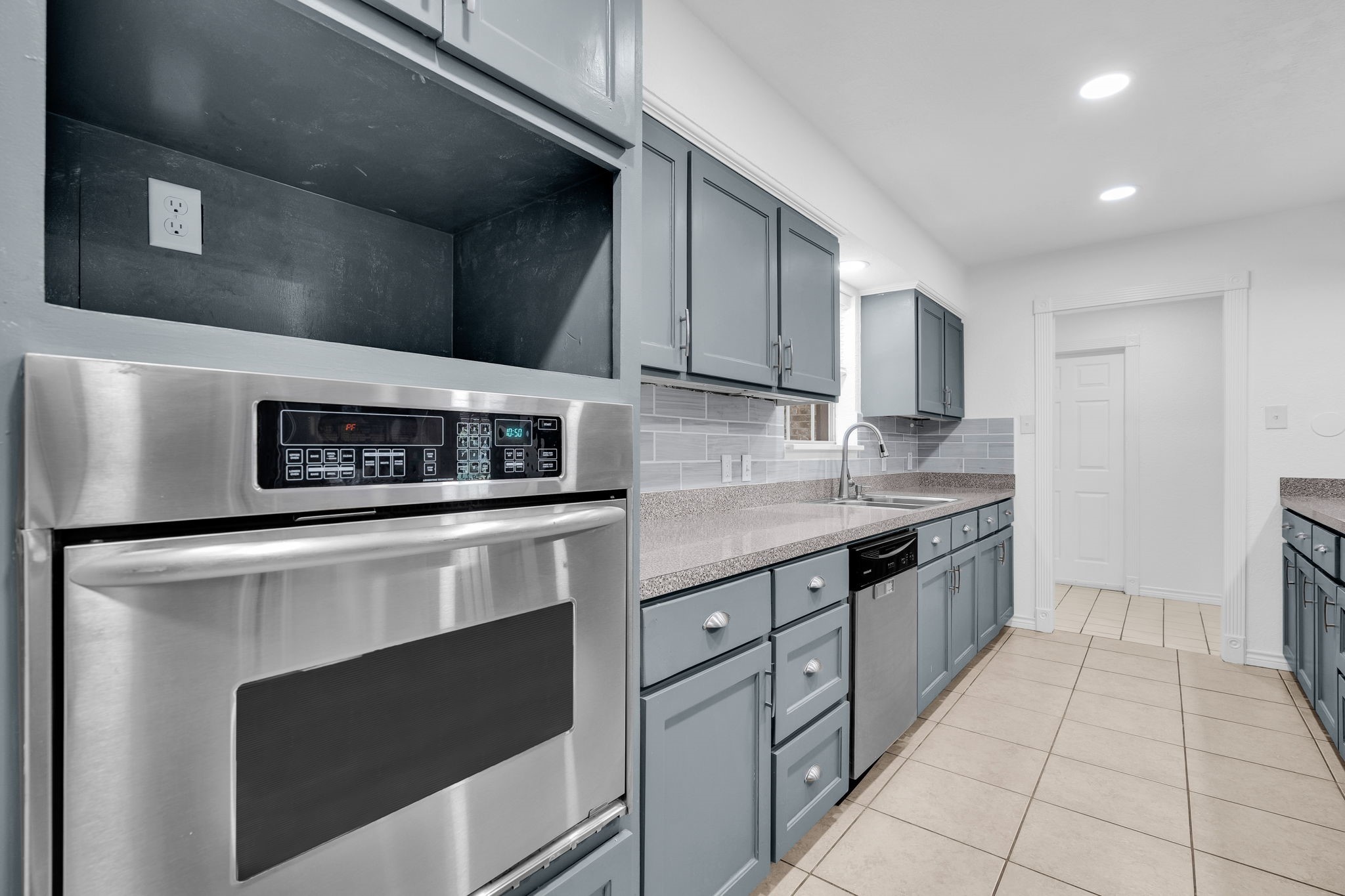 19811 Sagging Oaks Drive Spring, TX 77388 - Photo 10 of 35 a kitchen with stainless steel appliances granite countertop a stove and a microwave
