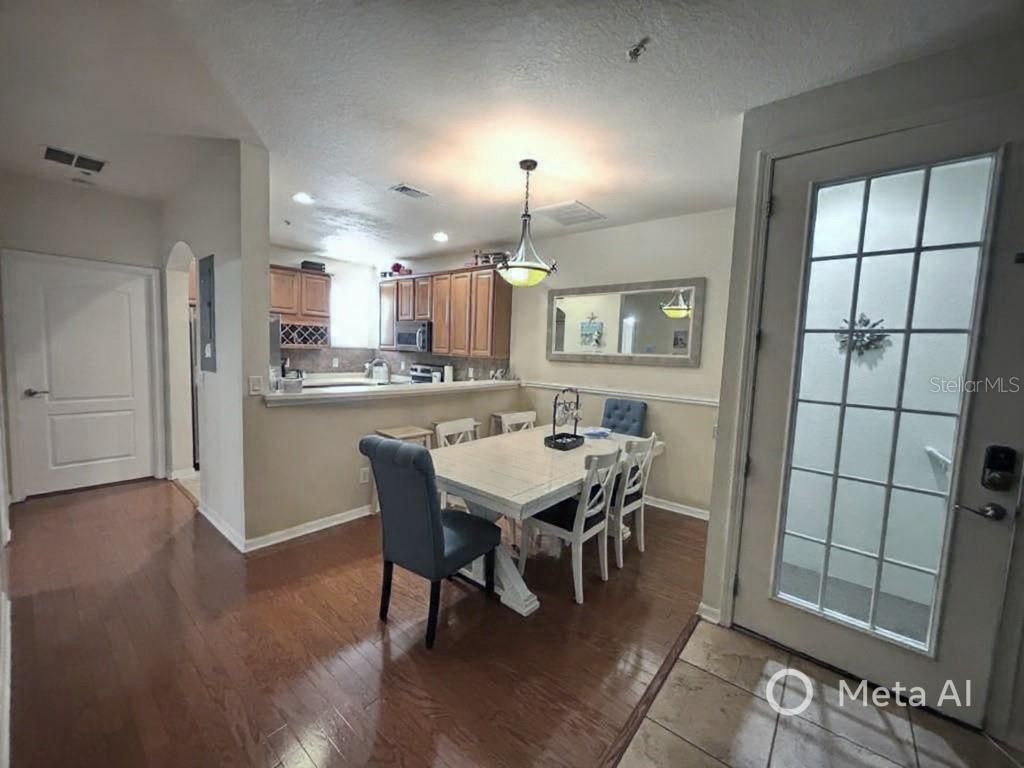 5633 Blackfin Drive New Port Richey, FL 34652 - Photo 16 of 46 a view of a dining room with furniture and wooden floor