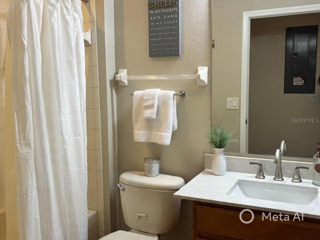 5633 Blackfin Drive New Port Richey, FL 34652 - Photo 24 of 46 a bathroom with a sink a toilet and shower curtain