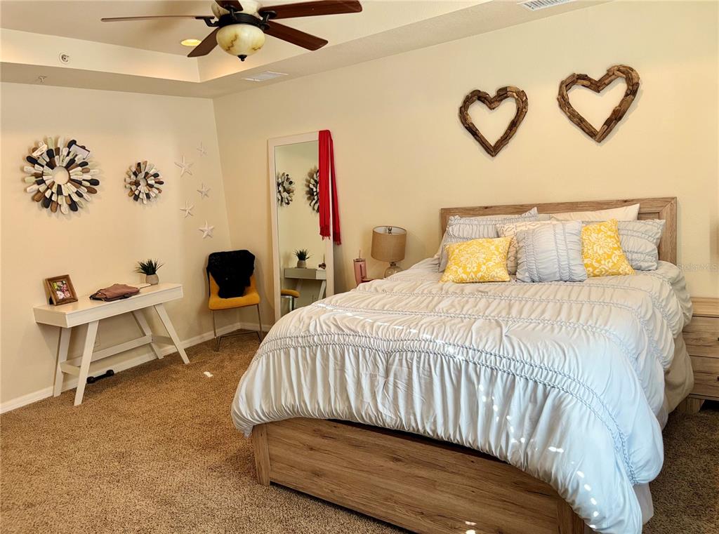 5633 Blackfin Drive New Port Richey, FL 34652 - Photo 35 of 46 a bedroom with a bed and a table in it