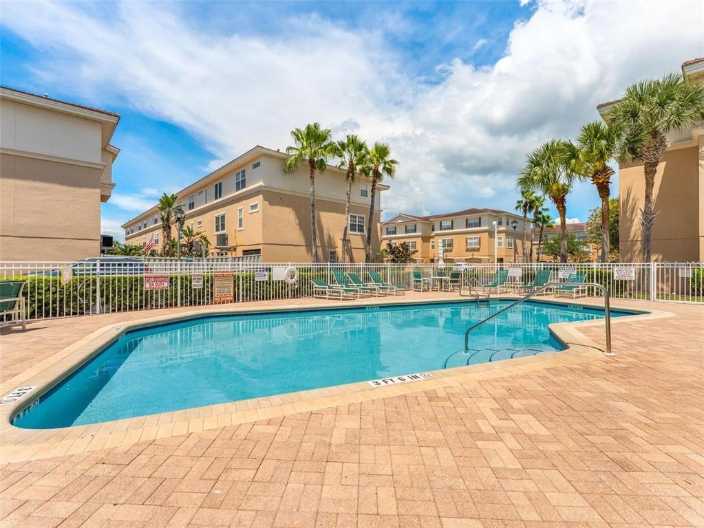 5633 Blackfin Drive New Port Richey, FL 34652 - Photo 39 of 46 a view of a swimming pool with a lounge chairs