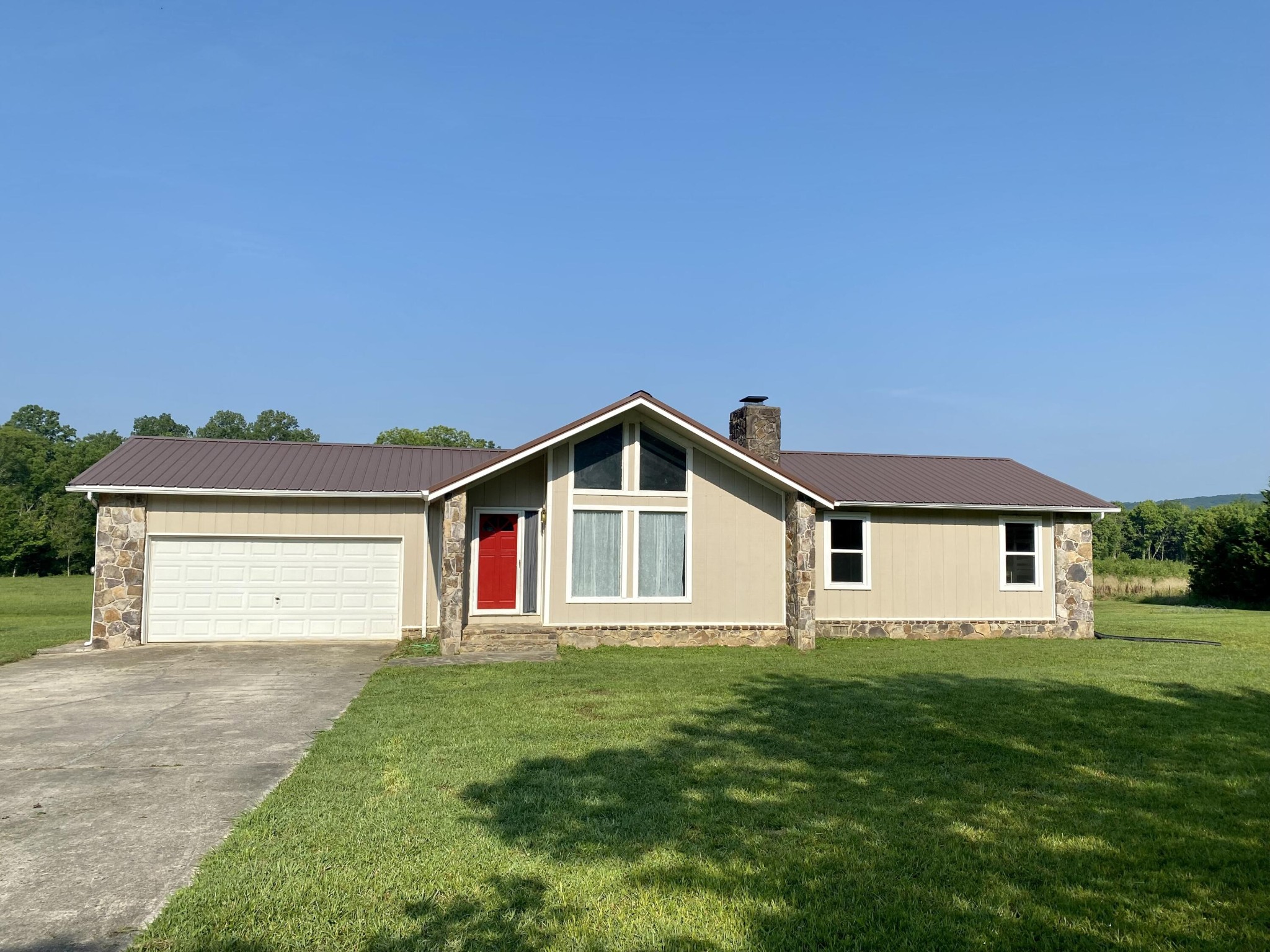 1724 Southeast Hunt Road Cleveland, TN 37323 - Photo 1 of 28 a front view of a house with a yard and garage