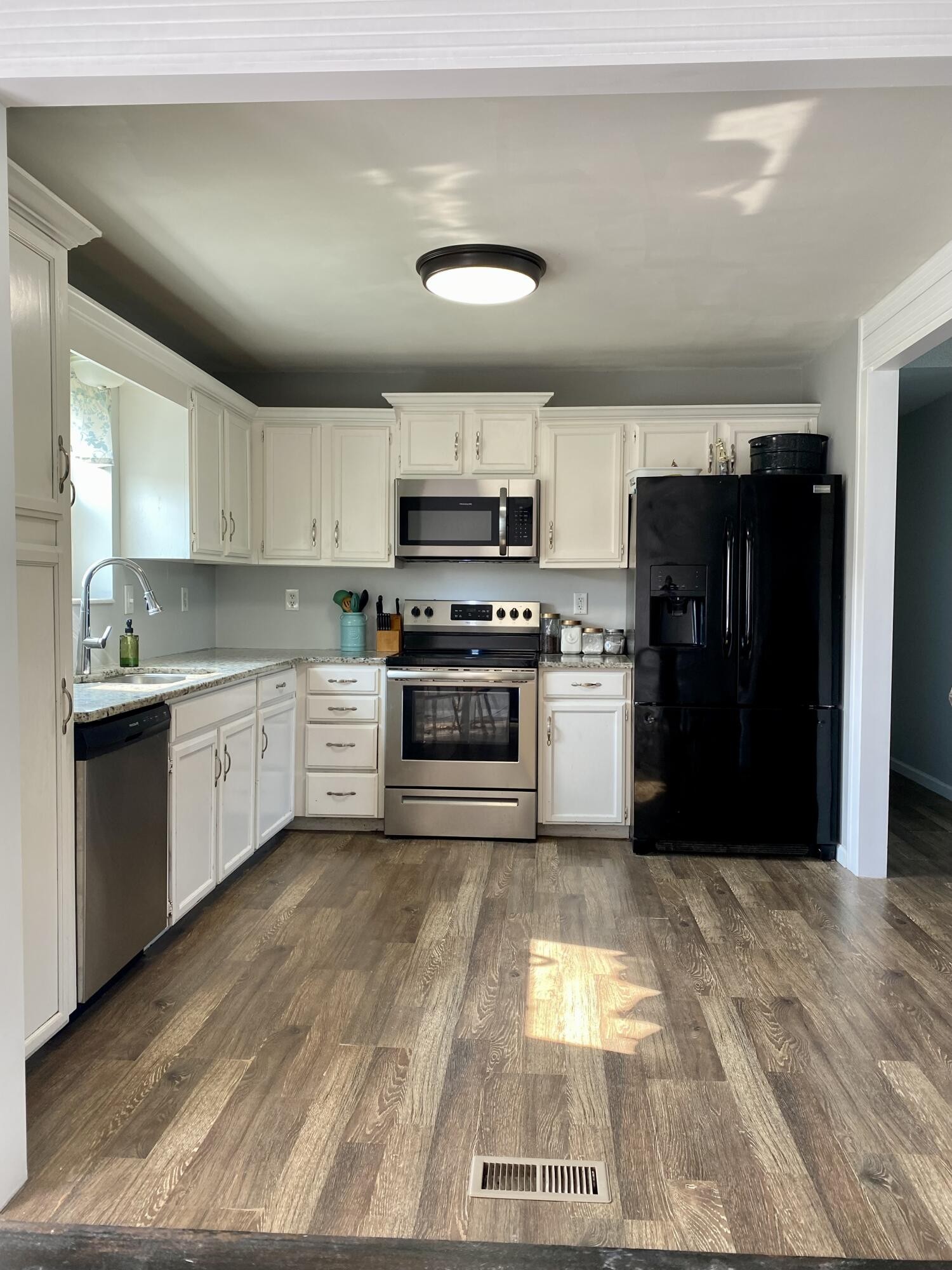 1724 Southeast Hunt Road Cleveland, TN 37323 - Photo 7 of 28 a kitchen with a stove a refrigerator and a microwave