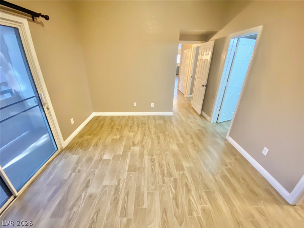 2000 Turquoise Ridge Street, Unit 204 Las Vegas, NV 89117 - Photo 28 of 29 Blonde wood-look flooring extends through the entire space, leading toward multiple interior doors.