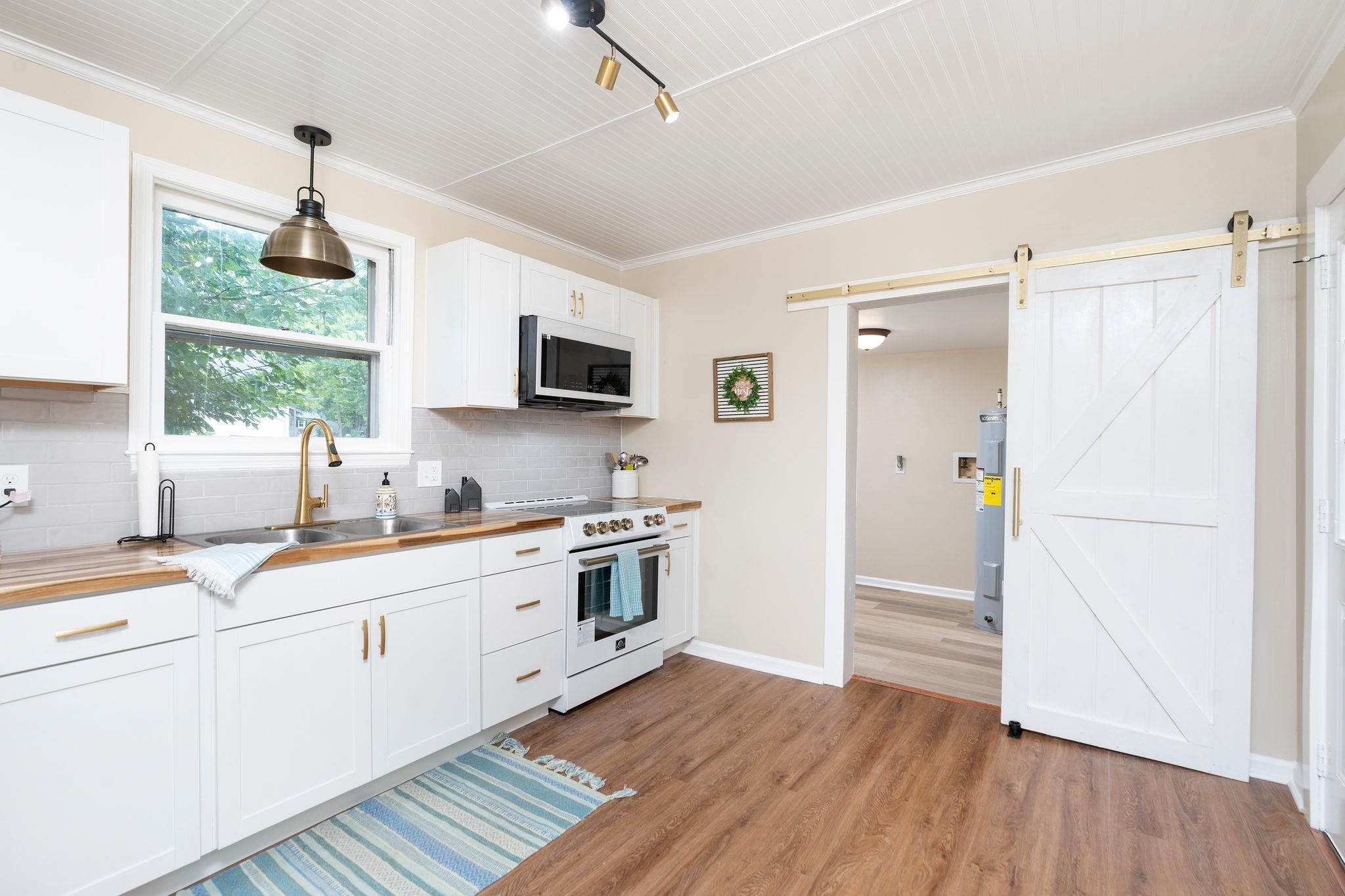 2302 Lee Highway Mount Sidney, VA 24467 - Photo 22 of 75 a kitchen with granite countertop a refrigerator stove and sink