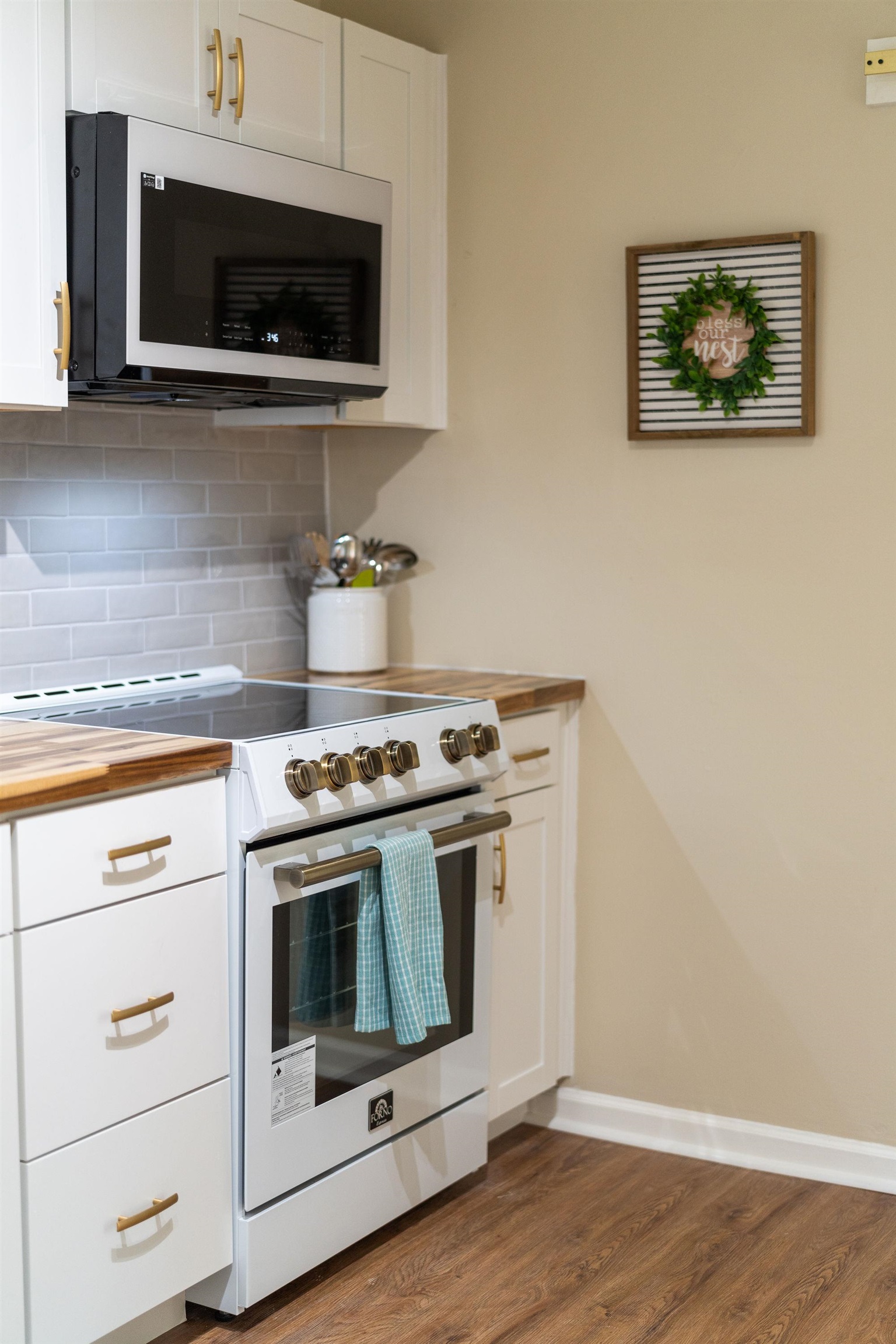 2302 Lee Highway Mount Sidney, VA 24467 - Photo 24 of 75 a stove top oven sitting inside of a kitchen with stainless steel appliances wooden floor and cabinets