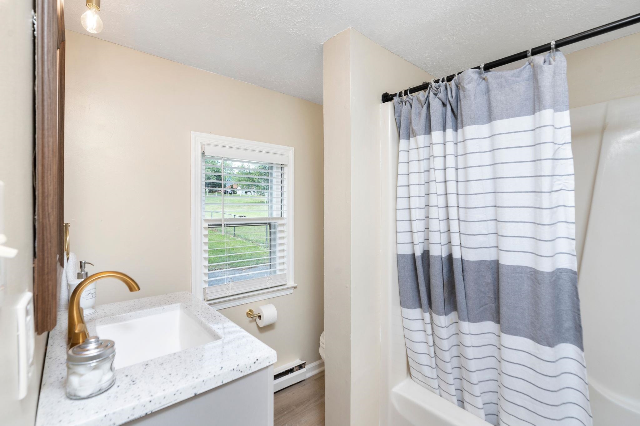 2302 Lee Highway Mount Sidney, VA 24467 - Photo 28 of 75 a bathroom with a shower curtain and a sink