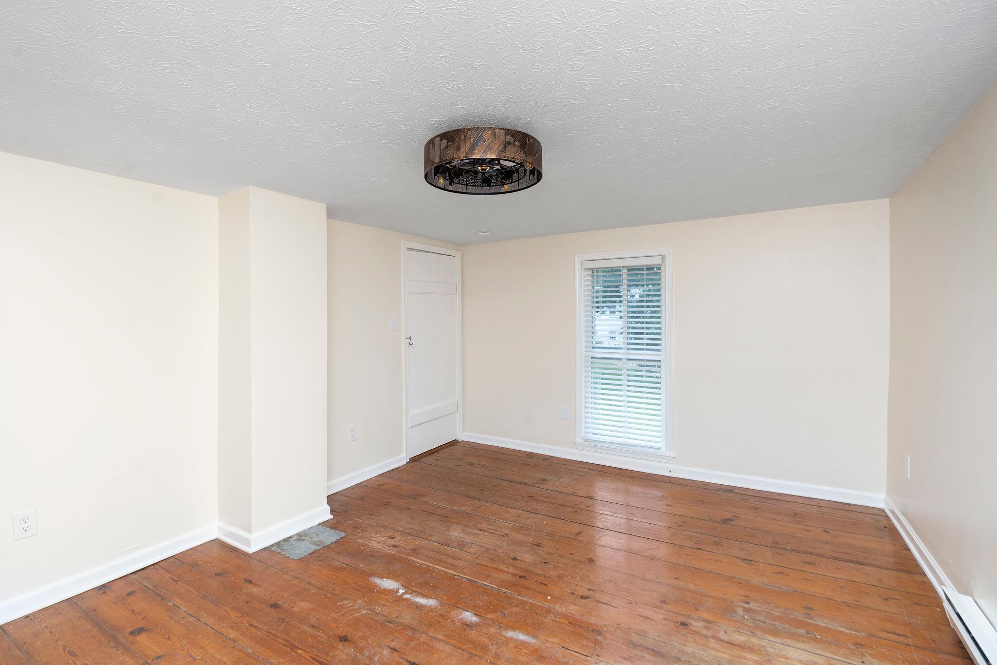 2302 Lee Highway Mount Sidney, VA 24467 - Photo 39 of 75 a view of an empty room with wooden floor and a window