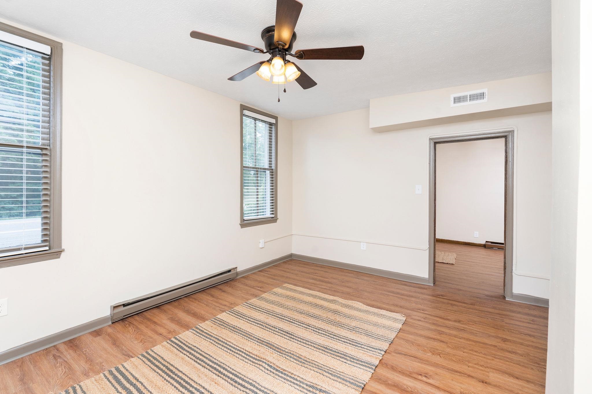 2302 Lee Highway Mount Sidney, VA 24467 - Photo 10 of 75 a view of an empty room with wooden floor and a window