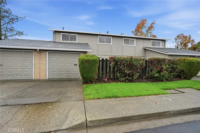 a front view of a house with a garden and garage