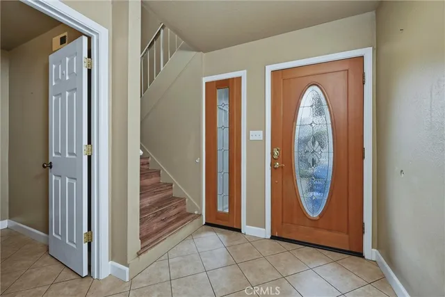 an entryway with wooden floor and front door