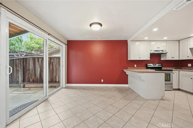 a kitchen with stainless steel appliances granite countertop a sink and a stove