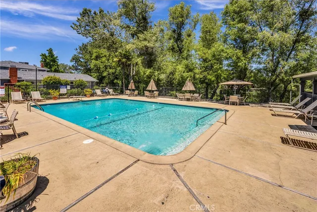 swimming pool view with a garden space