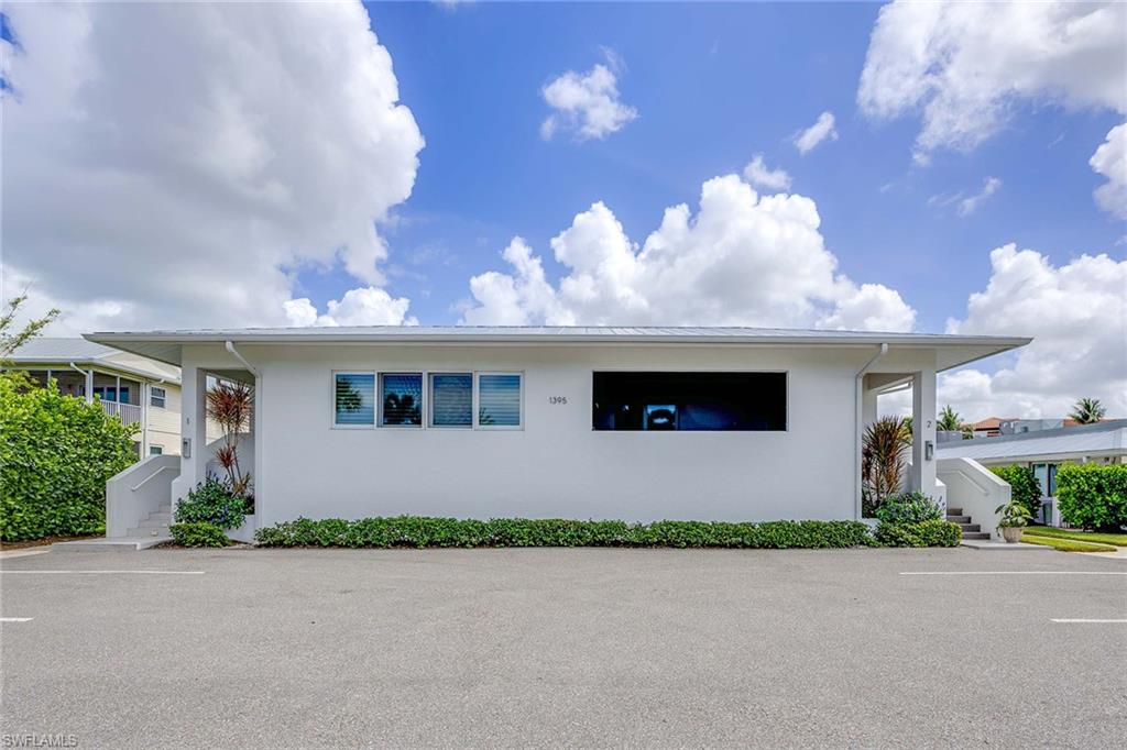 1395 Curlew Avenue, Unit 43 Naples, FL 34102 - Photo 23 of 24 a front view of a house with yard and parking