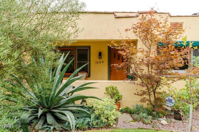 a view of a house with a tree beside it