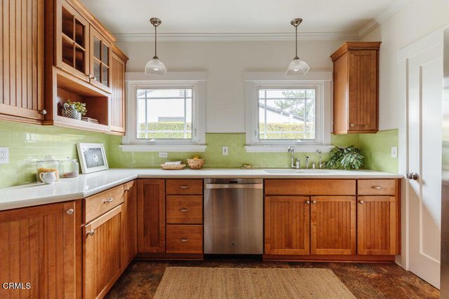 a kitchen with stainless steel appliances granite countertop wooden cabinets a sink and dishwasher