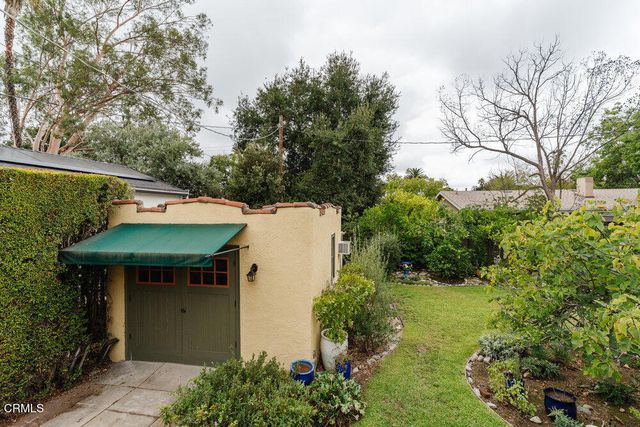 a view of a house with pool and sitting area