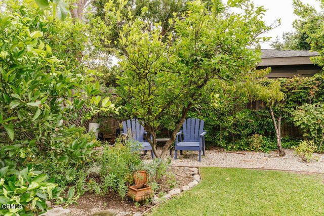 a wooden bench sitting in the middle of a yard