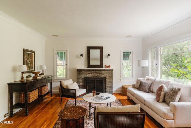 a living room with furniture fireplace and window