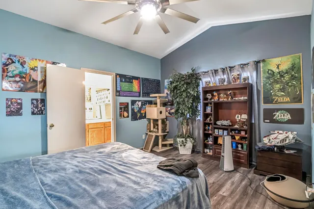 a bedroom with bed and wooden floor