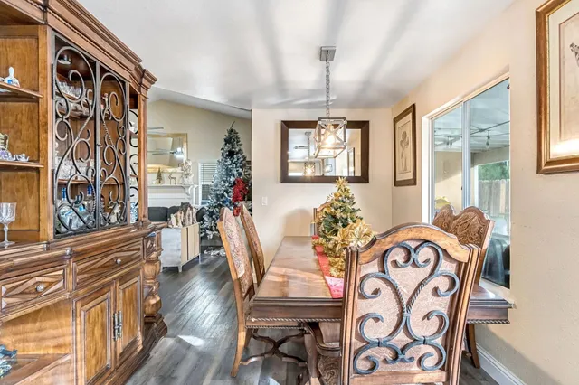 a view of a dining room with furniture wooden floor and chandelier