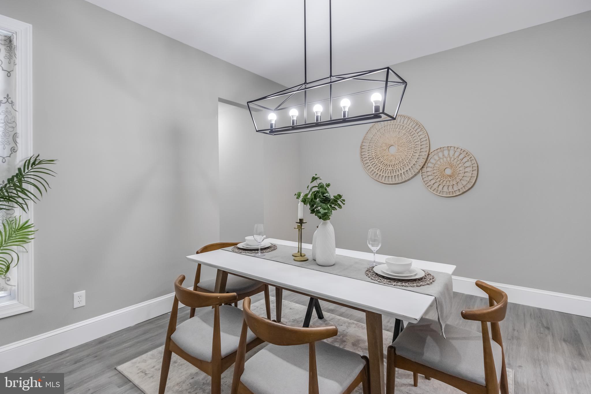 2817 Winchester Street Baltimore, MD 21216 - Photo 11 of 29 a view of a dining room with furniture a chandelier and wooden floor