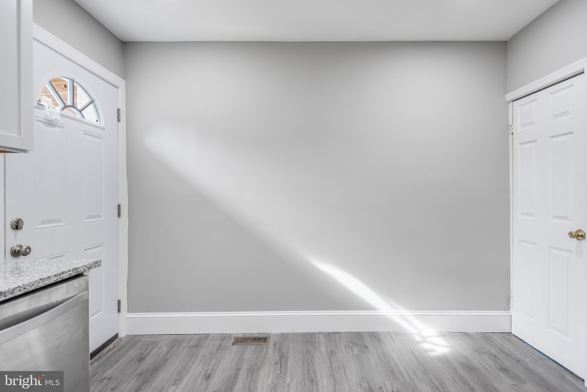 2817 Winchester Street Baltimore, MD 21216 - Photo 13 of 29 a view of an empty room and wooden floor