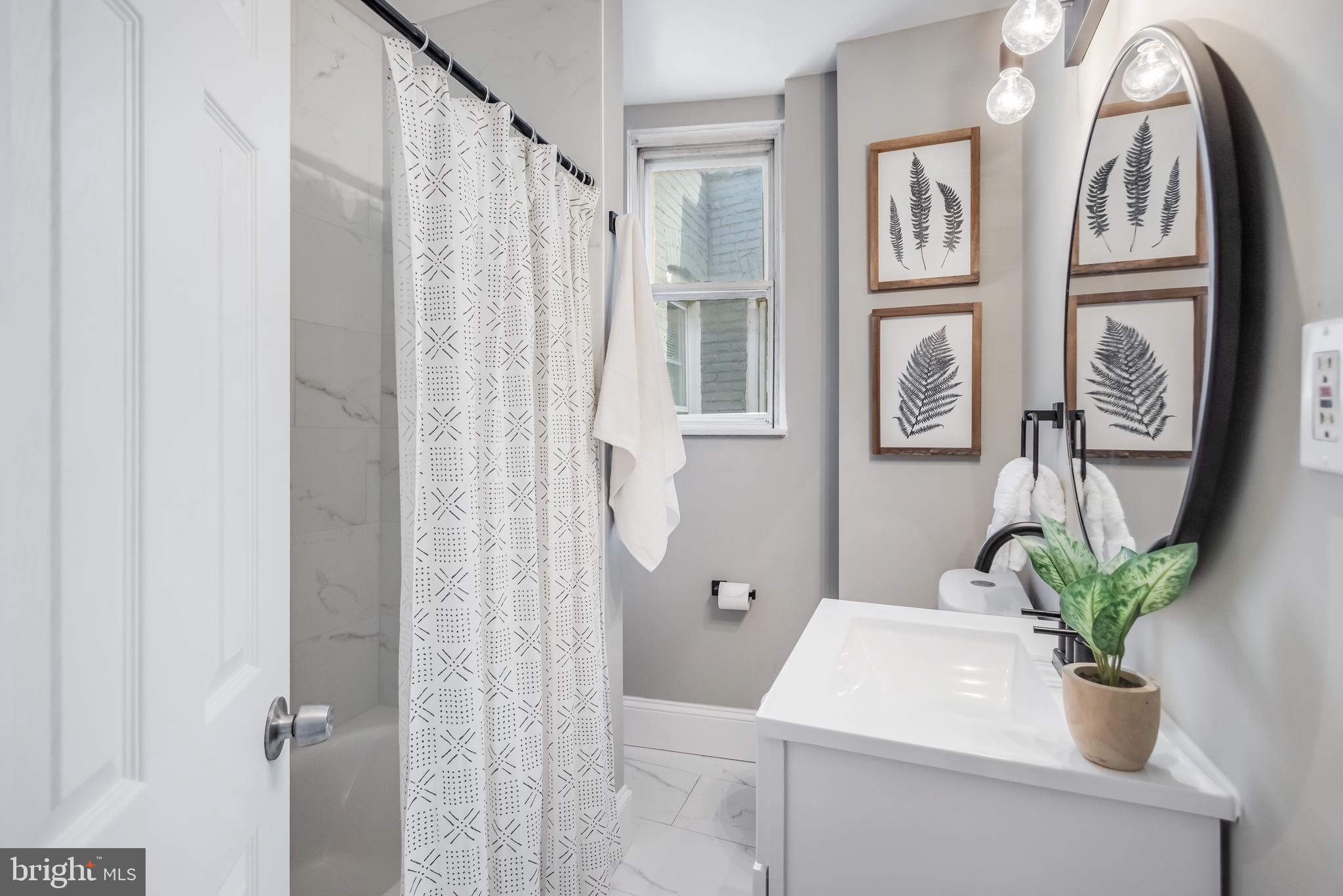 2817 Winchester Street Baltimore, MD 21216 - Photo 14 of 29 a bathroom with a sink toilet and shower