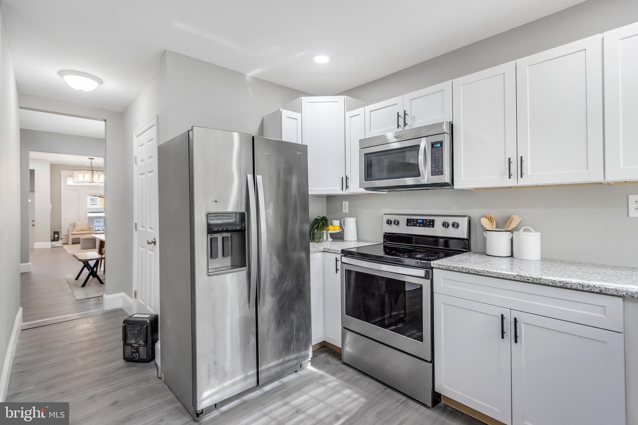2817 Winchester Street Baltimore, MD 21216 - Photo 15 of 29 a kitchen with stainless steel appliances granite countertop a refrigerator stove and sink
