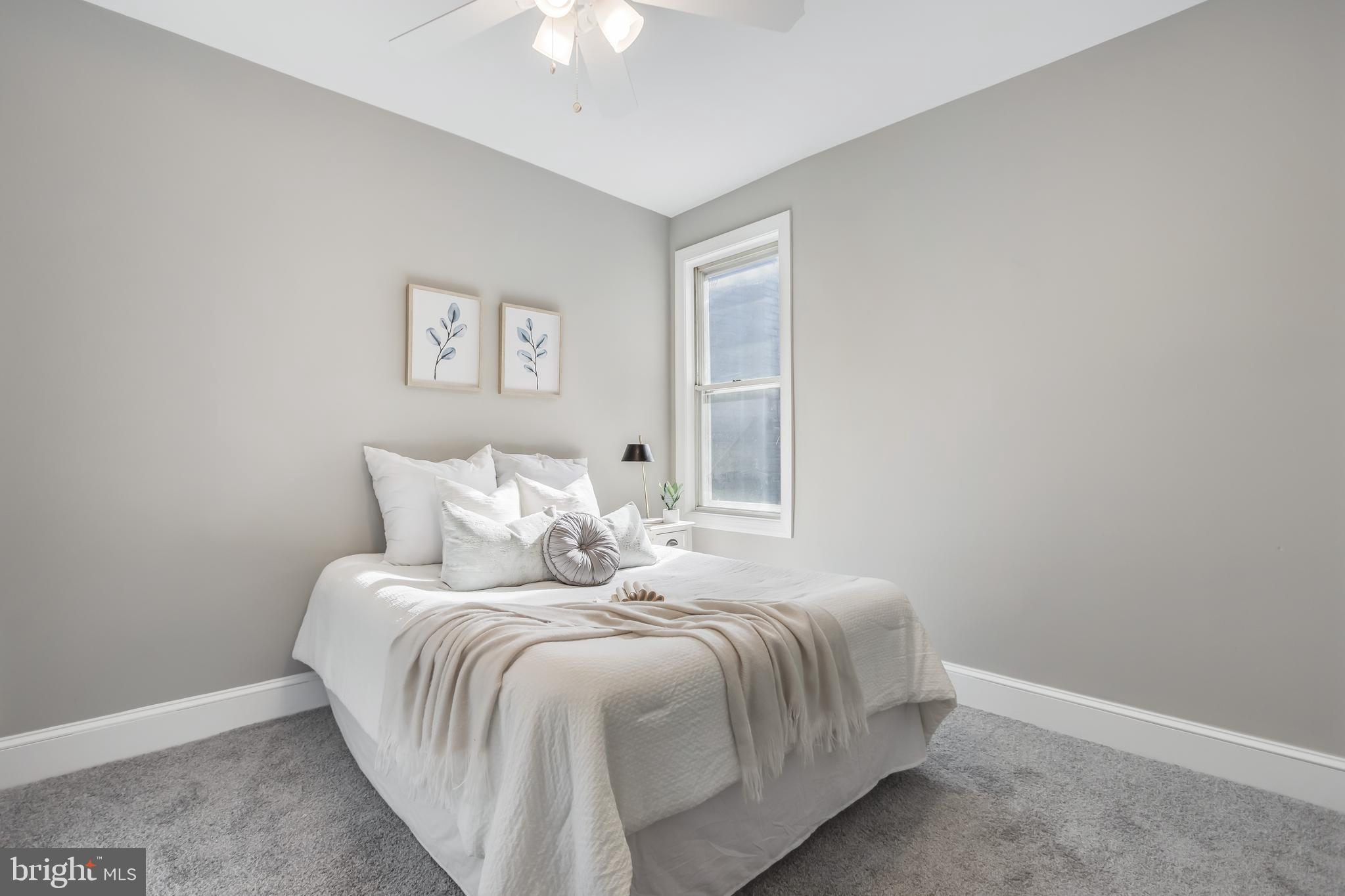 2817 Winchester Street Baltimore, MD 21216 - Photo 21 of 29 a bedroom with a bed and a chandelier