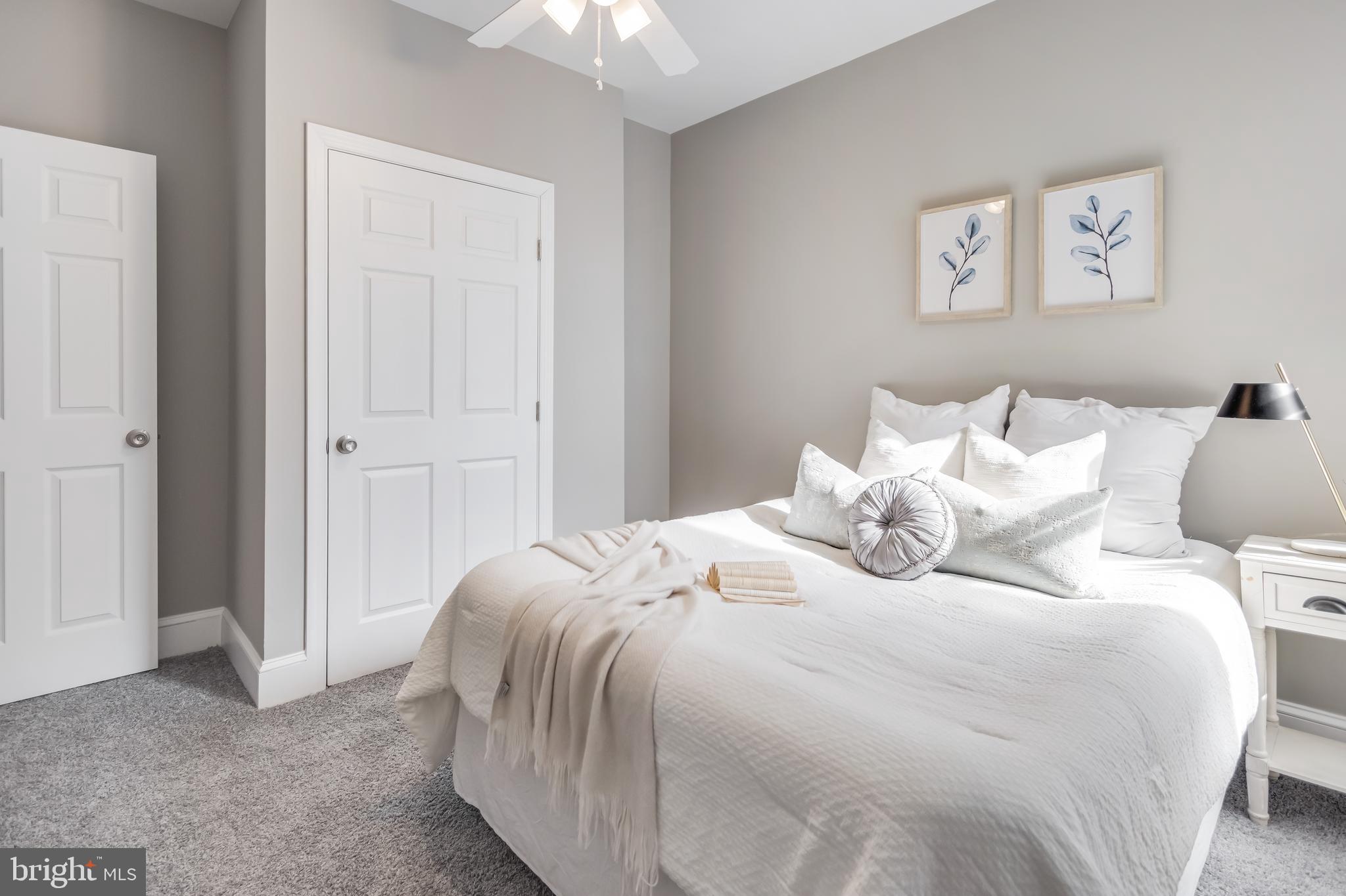 2817 Winchester Street Baltimore, MD 21216 - Photo 22 of 29 a bedroom with a bed and a chandelier
