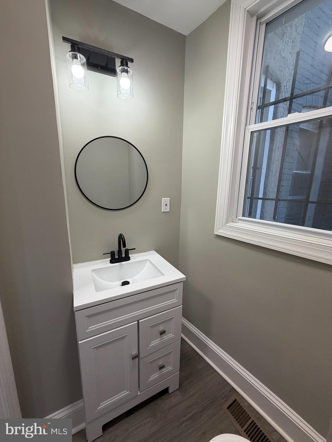2817 Winchester Street Baltimore, MD 21216 - Photo 27 of 29 a bathroom with a sink vanity and a mirror