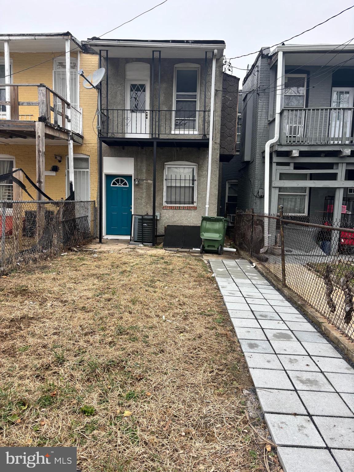 2817 Winchester Street Baltimore, MD 21216 - Photo 28 of 29 a view of a house with a barbeque and wooden stairs