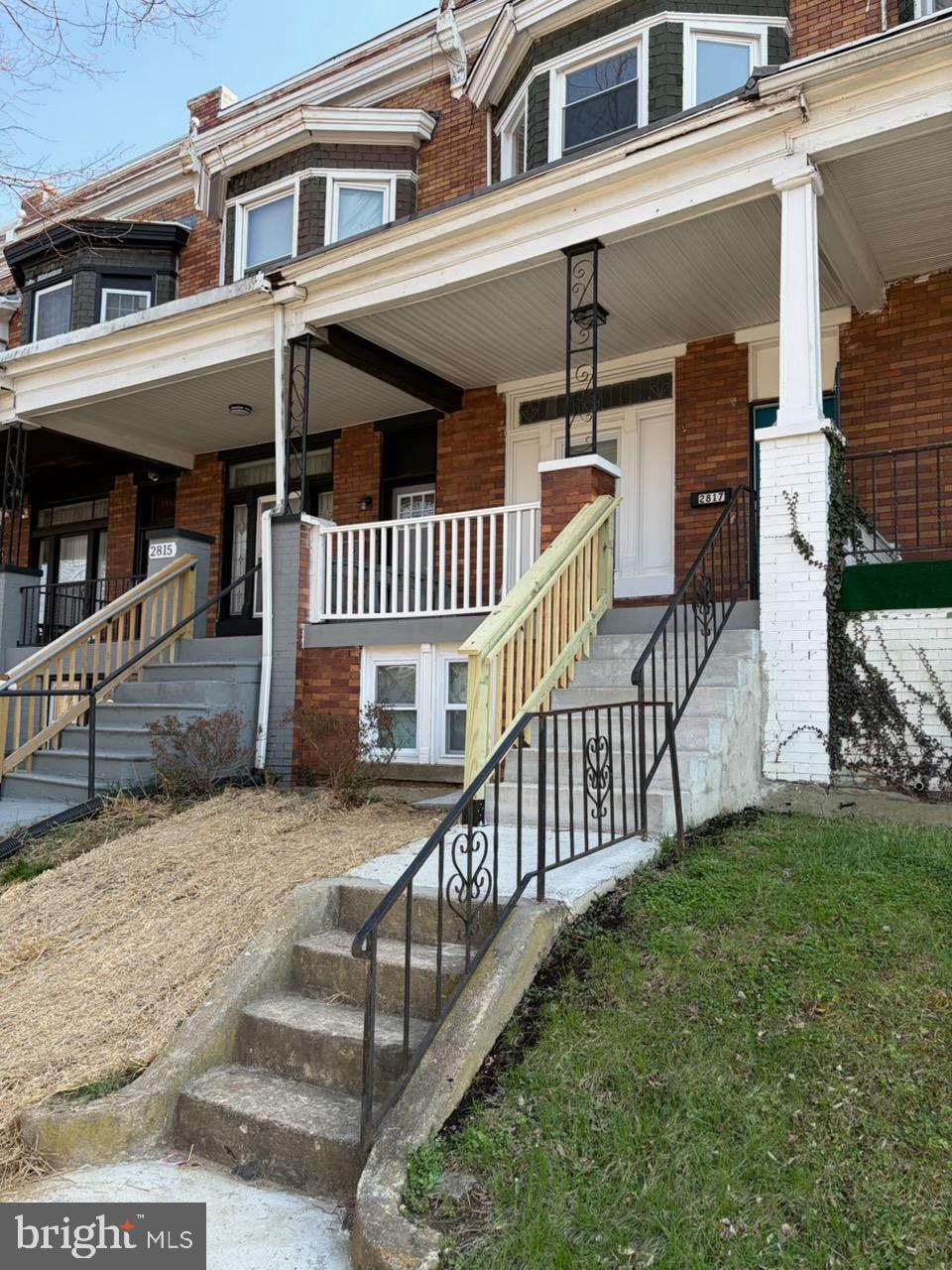 2817 Winchester Street Baltimore, MD 21216 - Photo 3 of 29 a view of a house with a small yard and wooden fence
