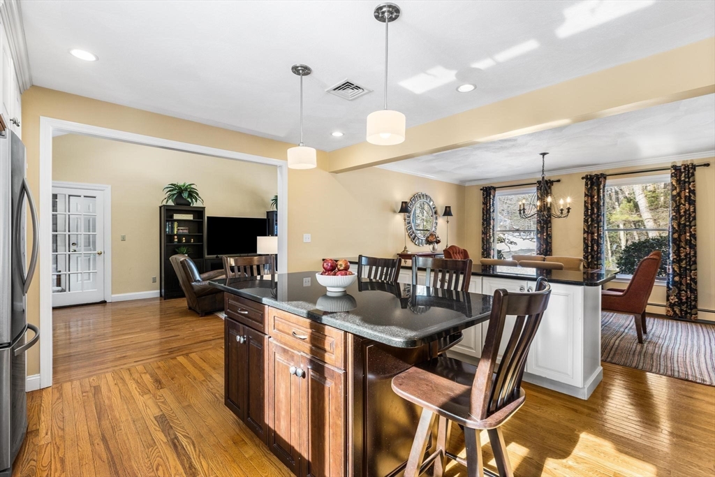 68 Sanborn Lane Reading, MA 01867 - Photo 12 of 42 a view of a dining room with furniture window and wooden floor