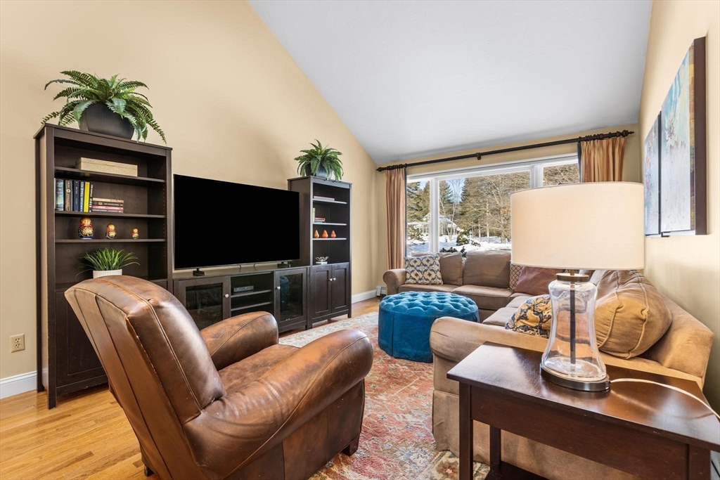 68 Sanborn Lane Reading, MA 01867 - Photo 13 of 42 a living room with furniture and a flat screen tv
