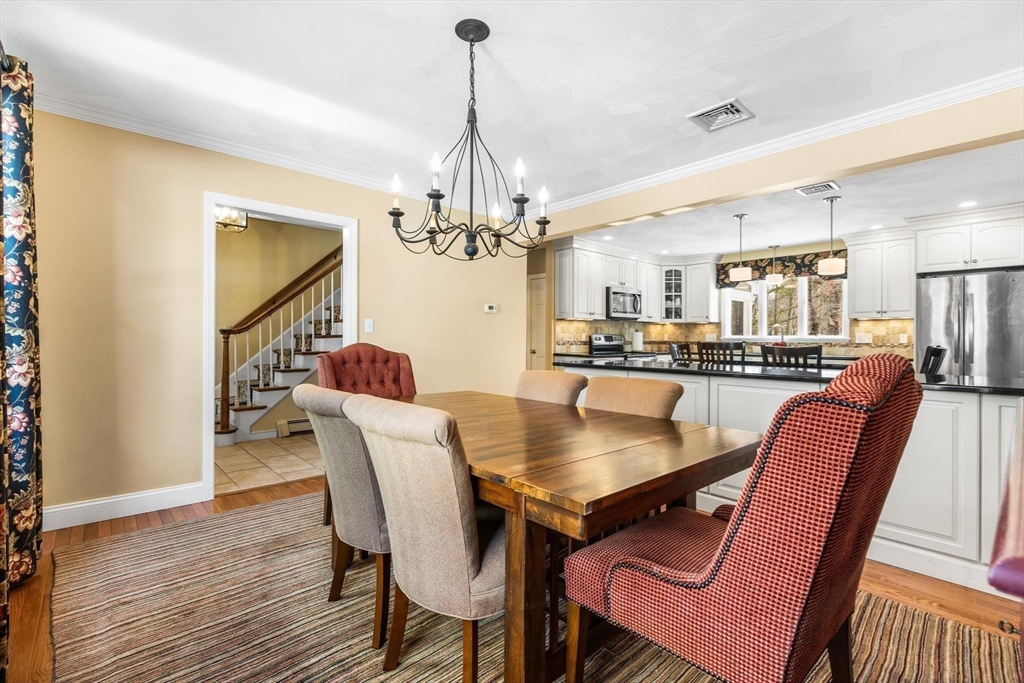 68 Sanborn Lane Reading, MA 01867 - Photo 14 of 42 a dining room with furniture and chandelier