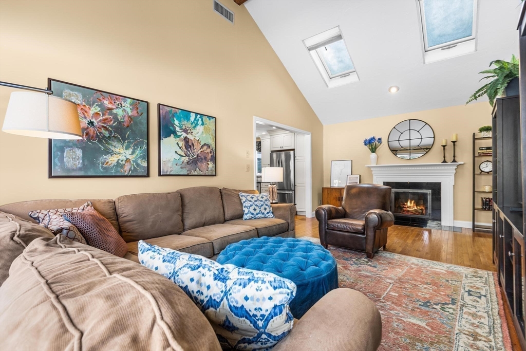 68 Sanborn Lane Reading, MA 01867 - Photo 16 of 42 a living room with furniture a fireplace and a large window