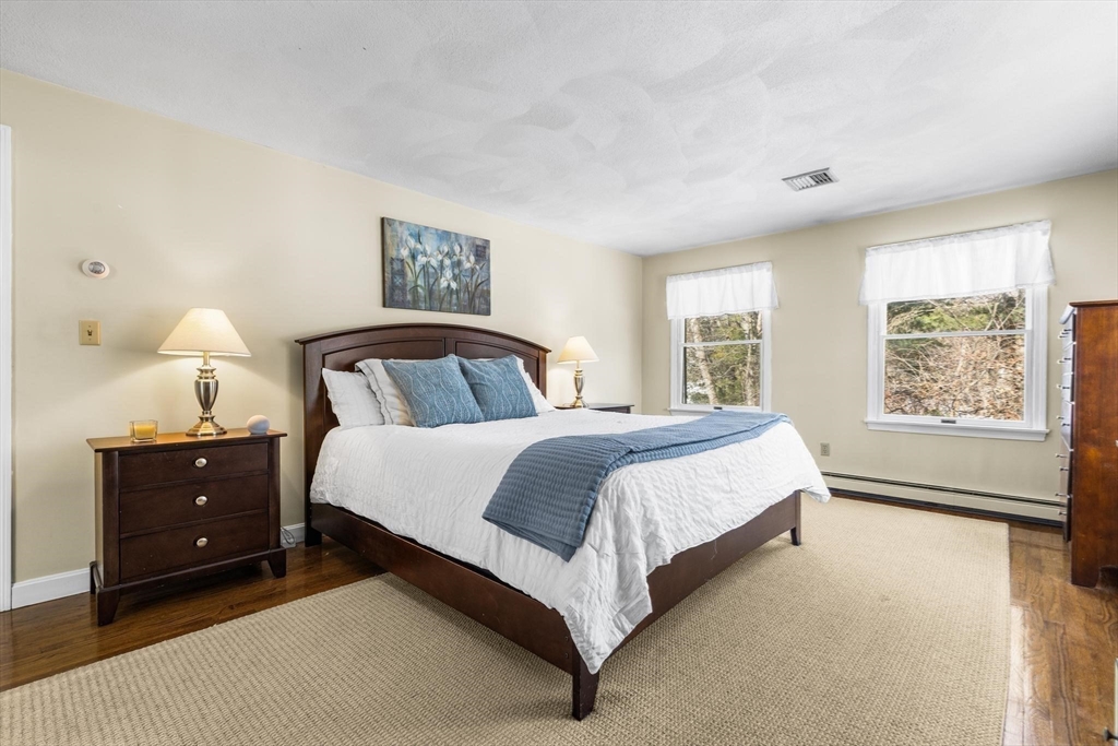 68 Sanborn Lane Reading, MA 01867 - Photo 18 of 42 a bedroom with a bed and window