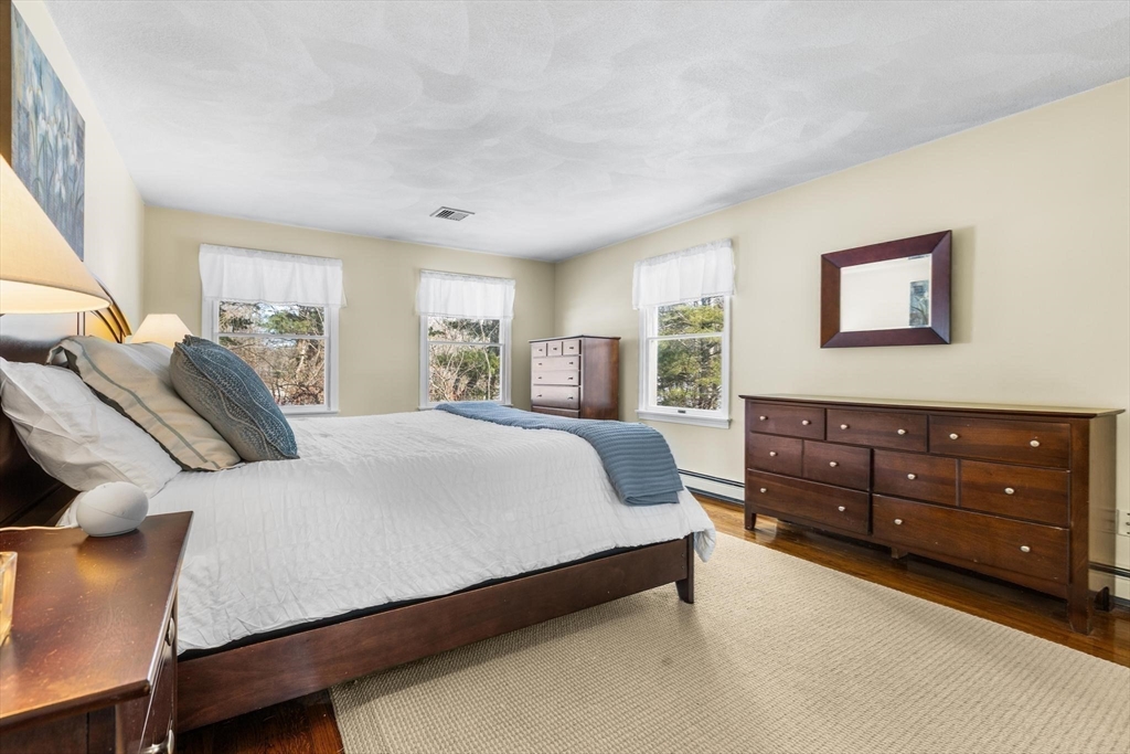 68 Sanborn Lane Reading, MA 01867 - Photo 20 of 42 a bedroom with a bed and window