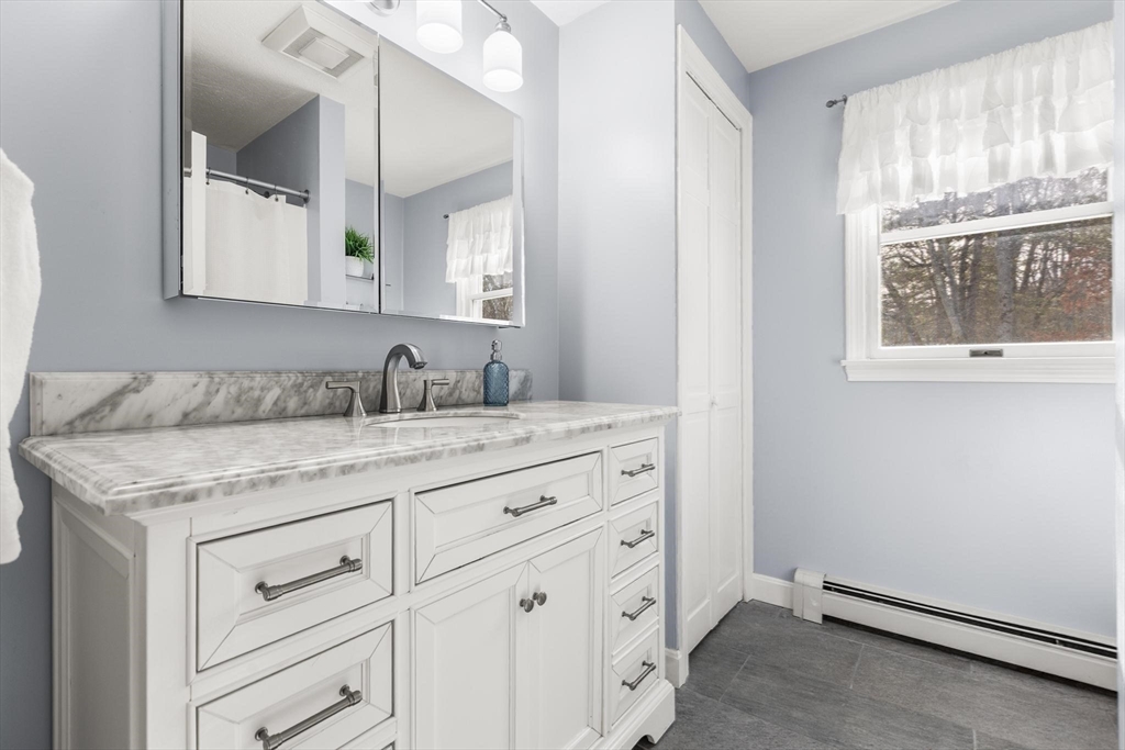 68 Sanborn Lane Reading, MA 01867 - Photo 21 of 42 a bathroom with a granite countertop sink and a mirror