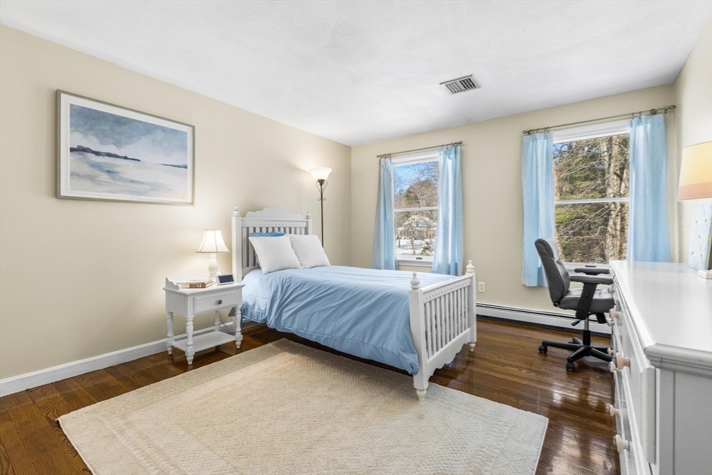 68 Sanborn Lane Reading, MA 01867 - Photo 22 of 42 a bedroom with a bed and a large window