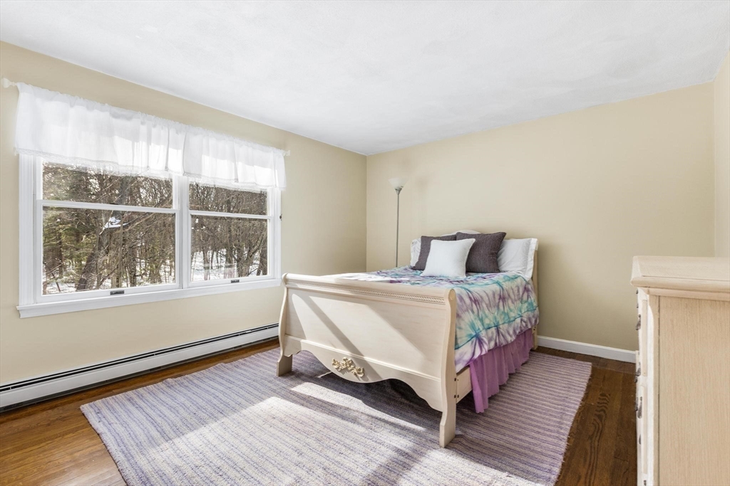 68 Sanborn Lane Reading, MA 01867 - Photo 23 of 42 a bedroom with a bed lamp and window