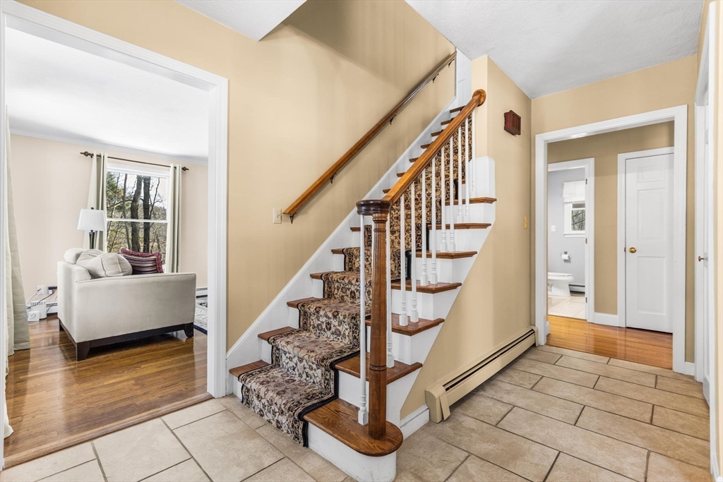 68 Sanborn Lane Reading, MA 01867 - Photo 3 of 42 a view of entryway and hall with wooden floor